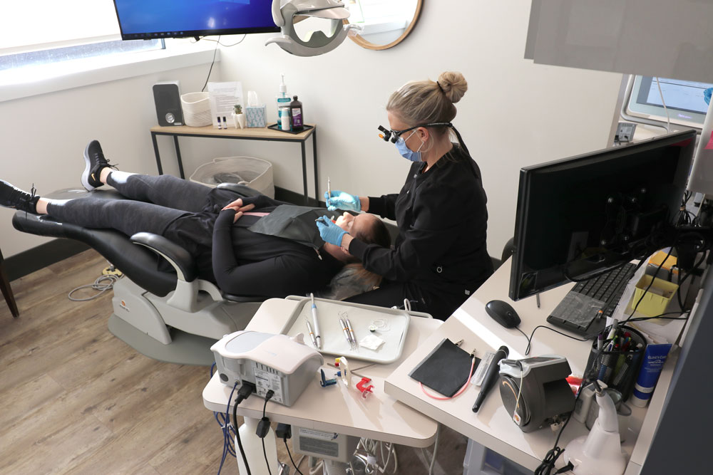 dental hygienist cleaning patients teeth