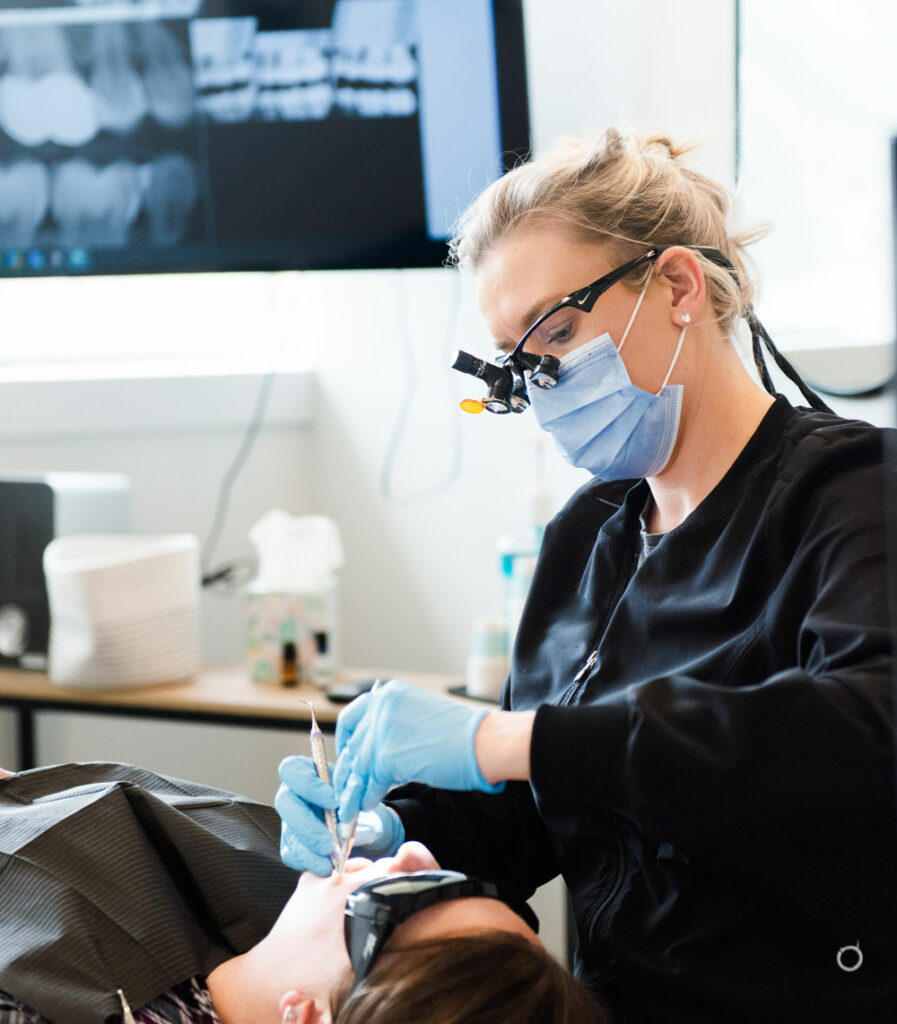 dental hygienist cleaning patients teeth