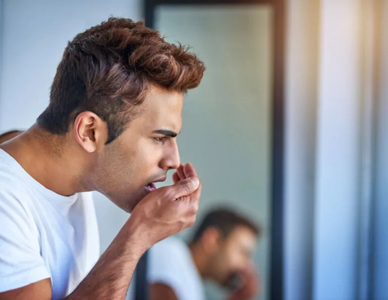man checking his breath