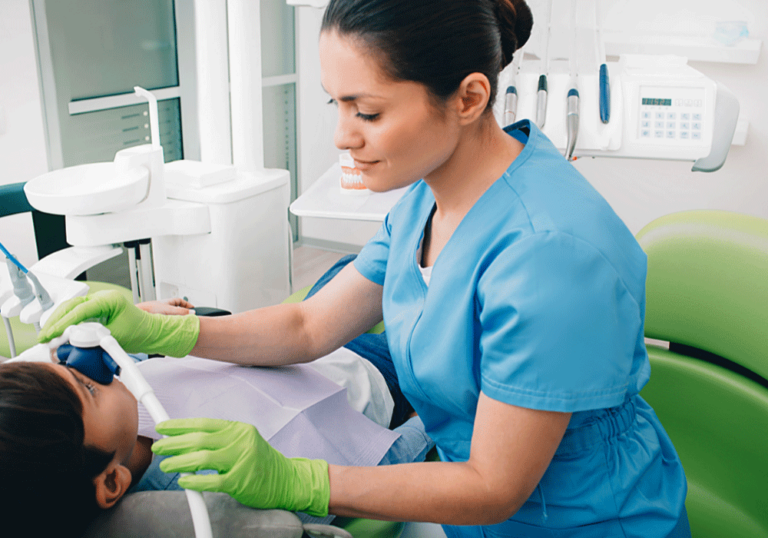 Hygienist providing sedation to a patient.